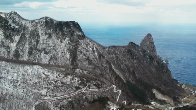 Snowy Coastal Cliffs Overlooking the Ocean