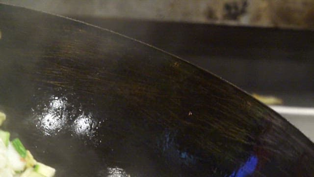 Vegetables being stir-fried in a wok