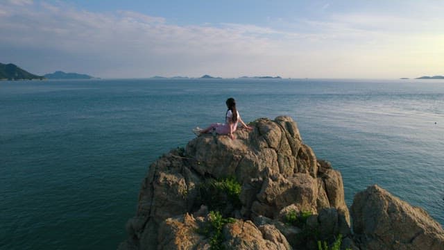 Woman Contemplating by the Seaside Cliff