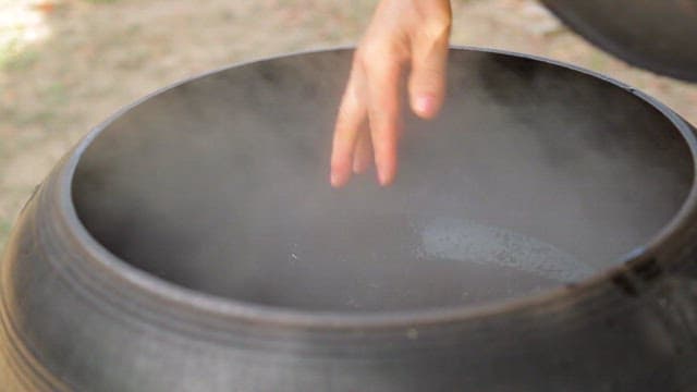 Adding seaweed to a steaming pot