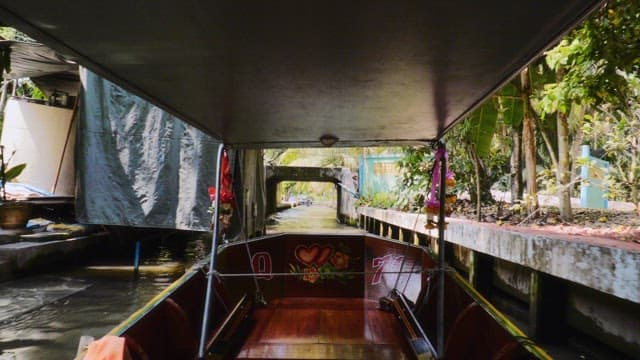 Taking a boat ride through lush rainforest on a clear day