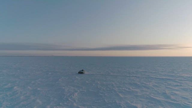 Car Crossing the Snowy Polar Region at Dusk