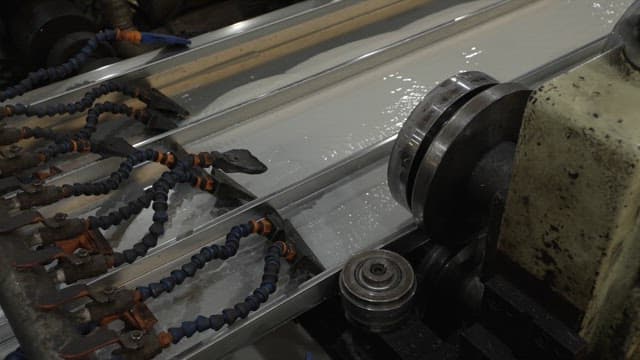 Metal sheet being processed in a factory