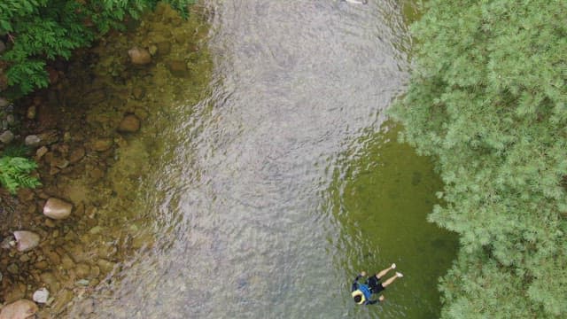 Person floating in a clear river