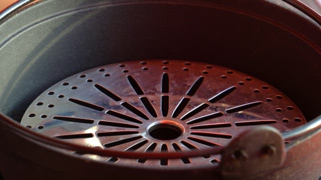 Pouring Water into a Perforated Metal Container