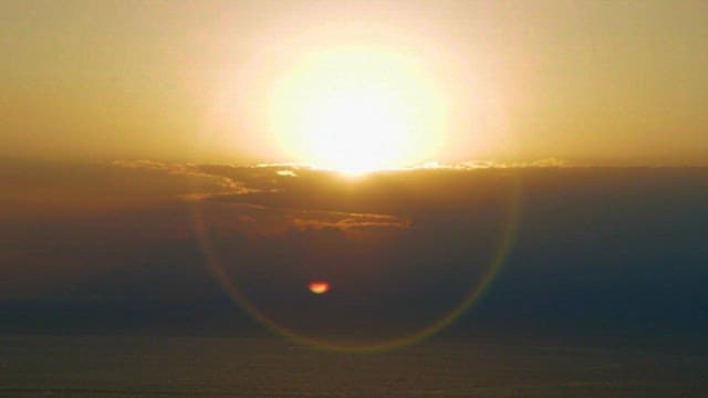 Sunrise over the Ocean with Light Lens Flare