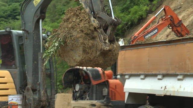 Excavator Loading Soil onto a Truck