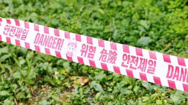 Grass Field with Caution Tape