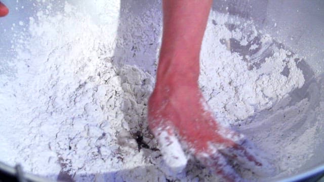 Hand-mixing starch in a large bowl