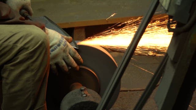 Sparks flying from a grinding machine