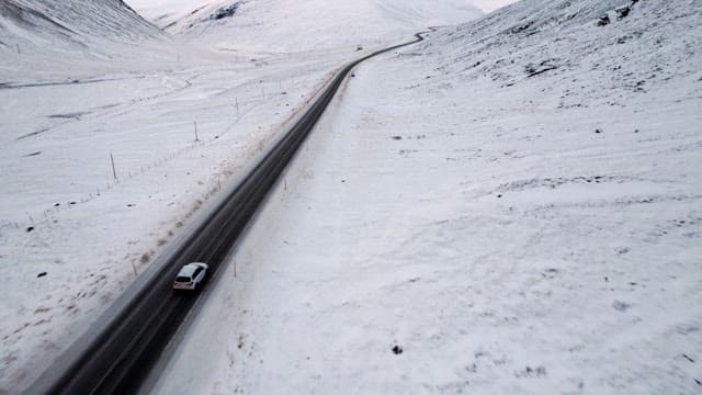 Car driving on a snowy mountain road