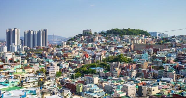 Day to night view of a densely populated residential area on a hill