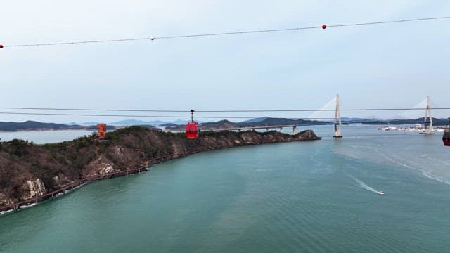 Cable cars over a scenic coastal view
