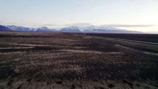 Vast landscape with distant snowy mountains