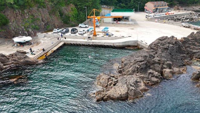 Coastal area with rocky shoreline and dock