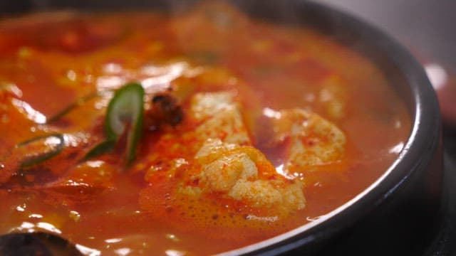 Soft tofu stew boiling in a ttukbaegi