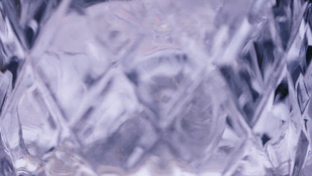 Drink Poured into a Crystal Glass Filled with Ice