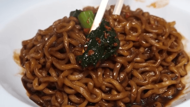 Jajang ramen in a white bowl served with kimchi