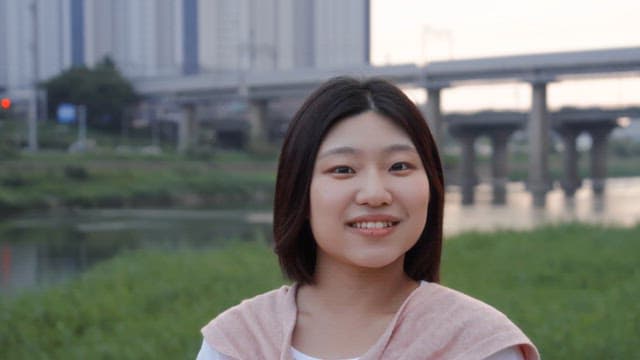 Woman smiling by the riverside