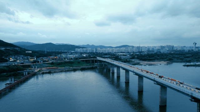 Bridge over a river with city skyline