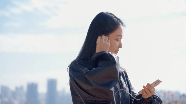 Woman listening to music outdoors