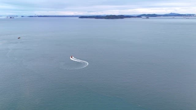 Boat making waves on a vast sea