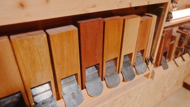 Collection of Woodworking Planes on a Shelf