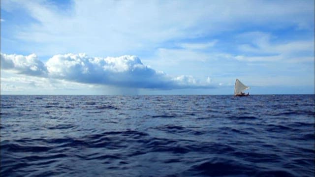 Sailboat navigating the open blue sea