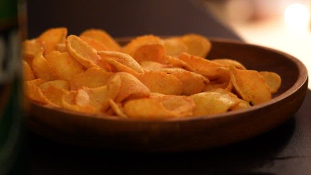 Close-Up View of Seasoned Chips in a Wooden Bowl