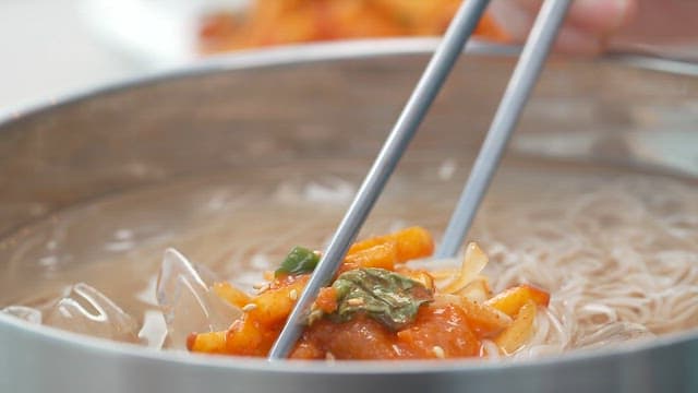 Chopstickful of noodles with sour cold raw fish soup