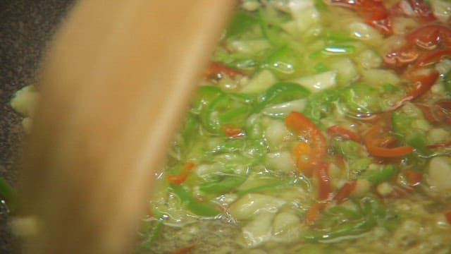 Chopped vegetables sizzling in a pan