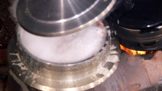 Cooking Soup in a Traditional Pot over Fire