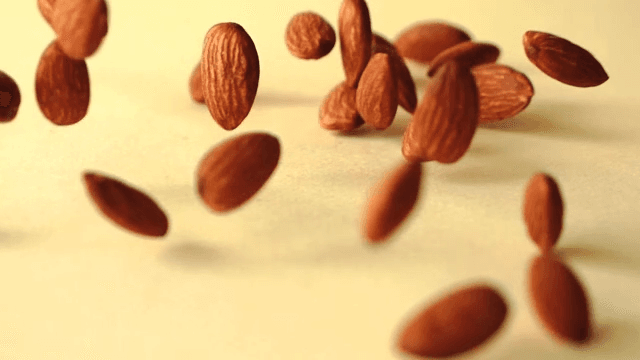 Almonds falling on yellow ground