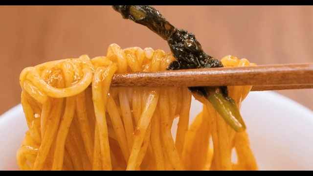 One Chopstick of Jjolmyeon Well Soaked in Red Seasoning