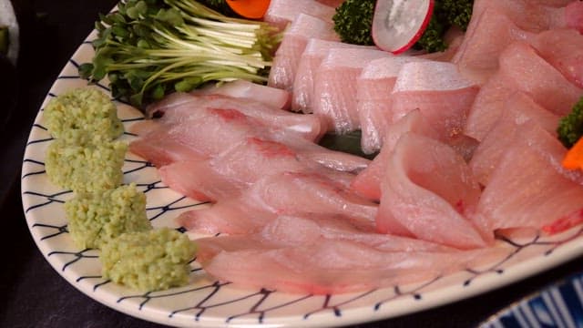 Freshly sliced yellow tail sashimi on a plate