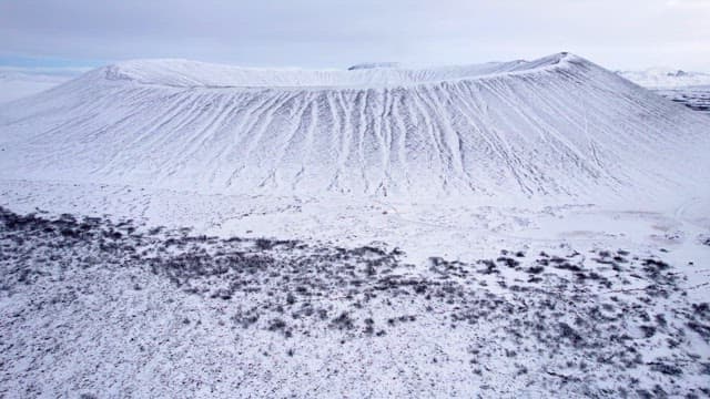 Snow-covered volcanic crater in winter