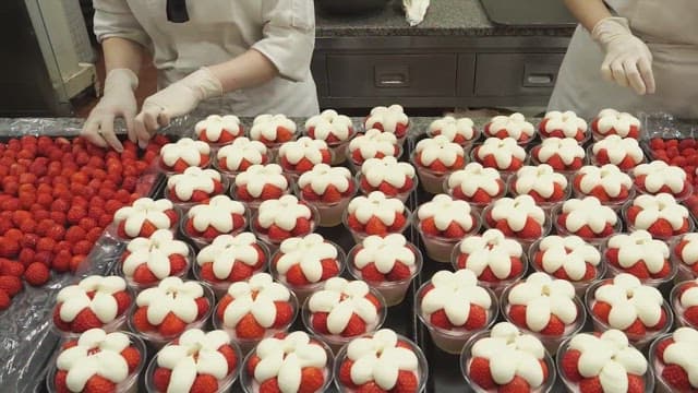 Decorating strawberry desserts in the kitchen