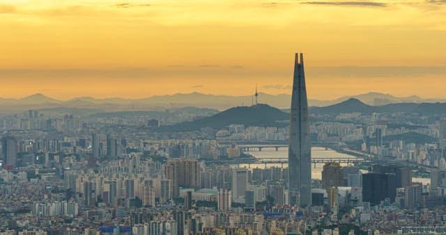 Panoramic view of the bustling city skyline and red sunset