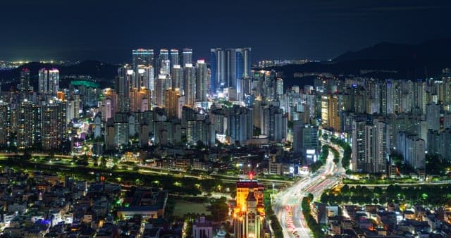 Night view in Daegu with illuminated buildings and busy traffic