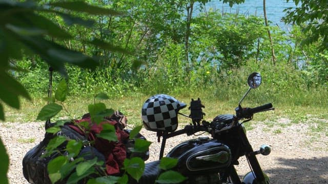 Motorcyclist getting ready to ride at a lakeside