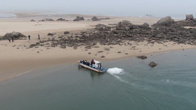 Boat anchored near the coastal cliffs