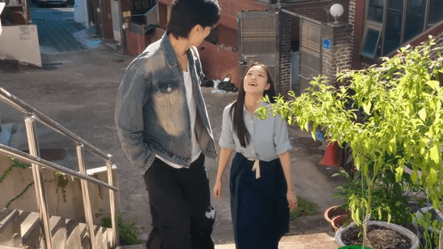 Couple walking up sunny stairs