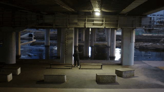 People exercising on the riverside under the bridge