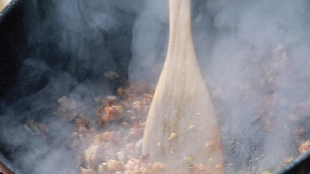 Stir-frying minced vegetables and meat in a pan