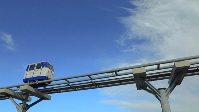Monorail Moving along Tracks Against a Clear Blue Sky