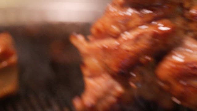 Seasoned meat grilled and cut in a pan