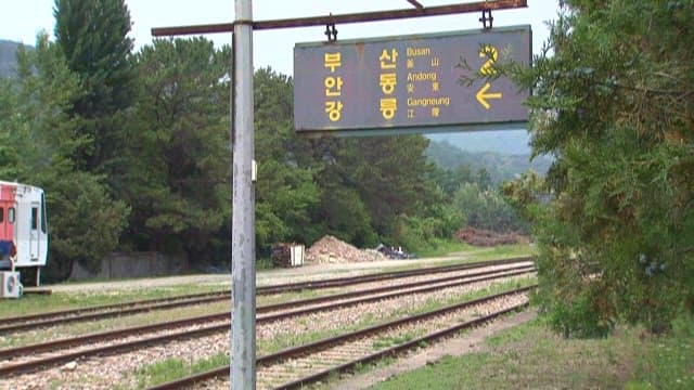 Railroad Signs and Train at a Rural Station