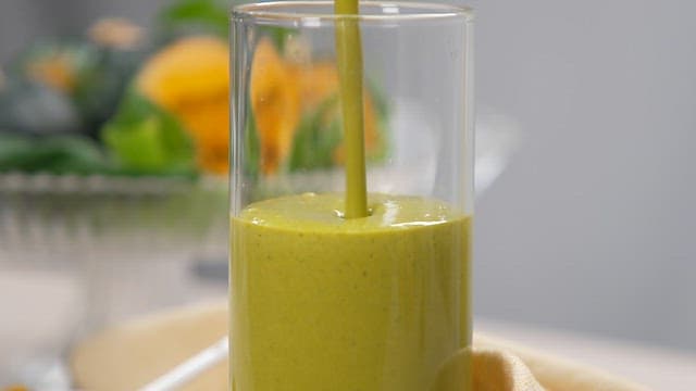 Pouring a Fresh Pumpkin Juice into a Glass