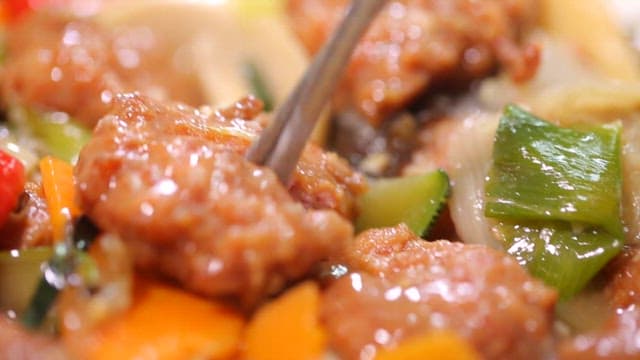 Chopstickful of delicious stir-fried meatballs and vegetables