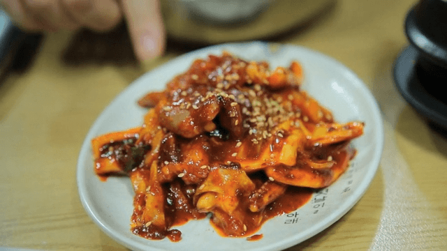 Plate of stir-fried squid and pork served on a restaurant table
